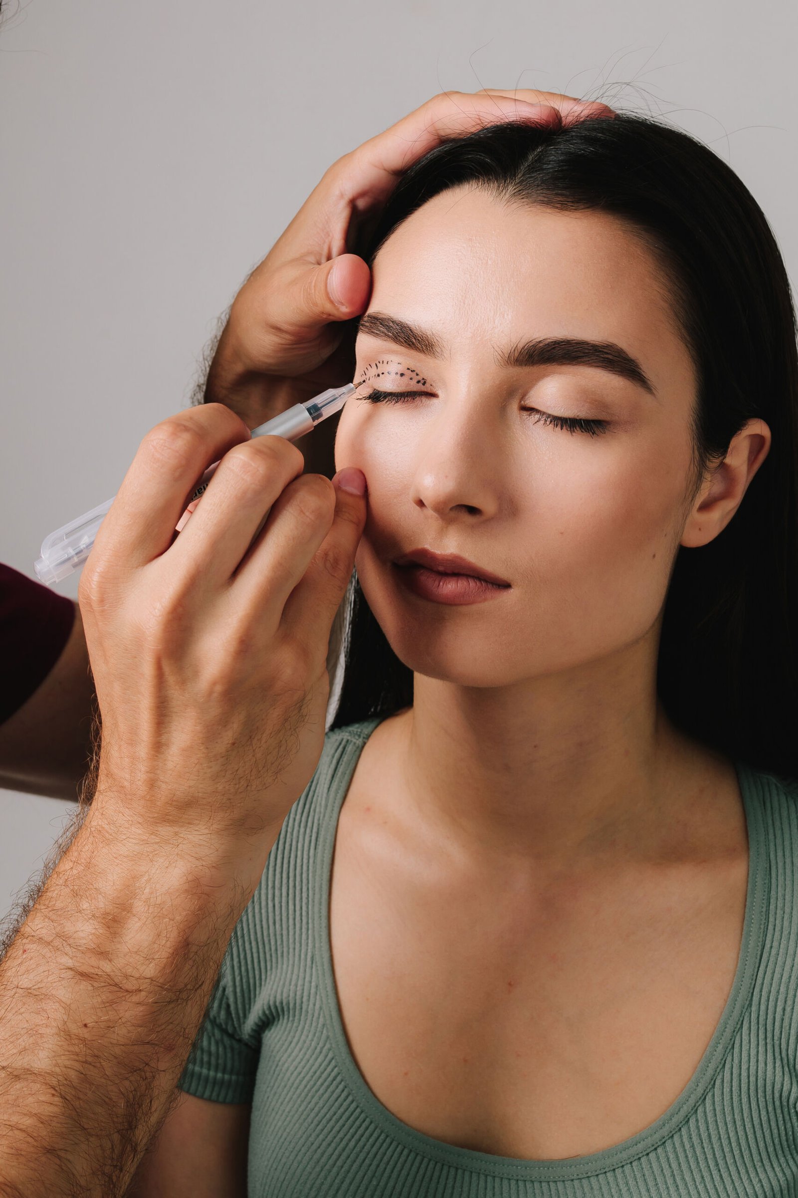 Blepharoplasty. Drawing on skin of eyelids for accurate face lifting and safe surgery to remove excess skin. Plastic surgeon is marking up contour for upper blepharoplasty.