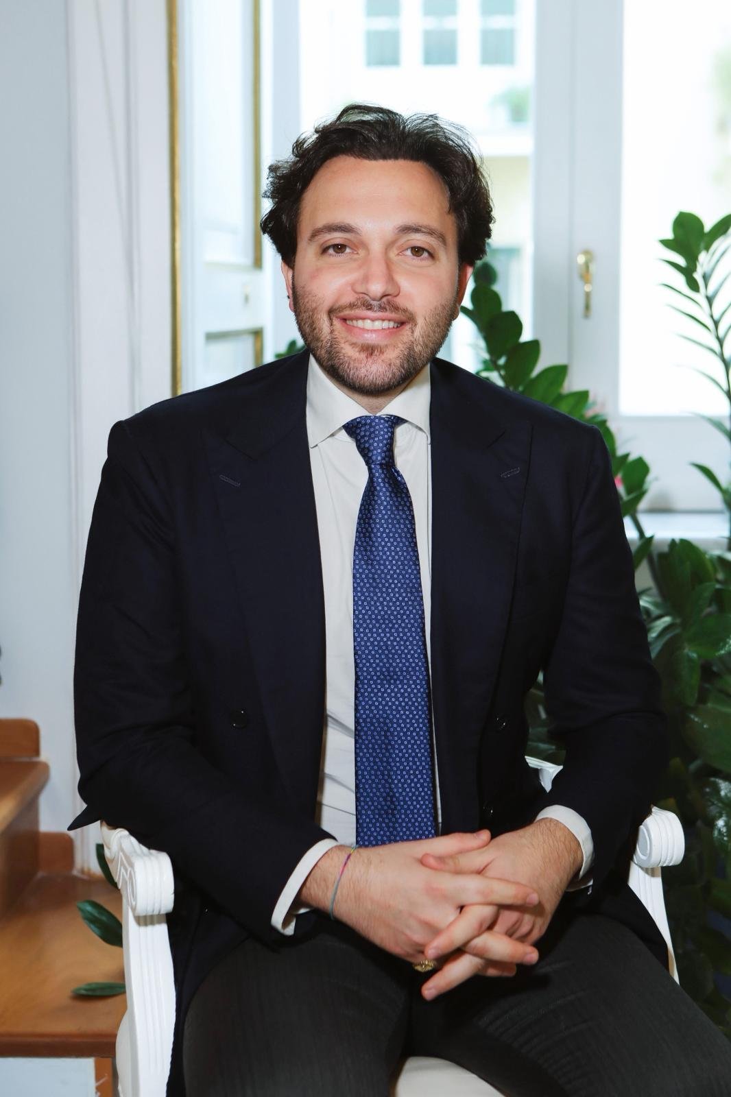 Professional photo of Dr Leonardo sitting in an office wearing a suit